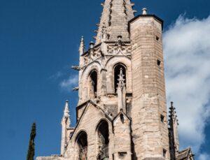 [the spires of a Gothic palace against a blue sky] Wine tourism France, Avignon France, Avignon Wine Tours, wine schools in France. St. Martial Tower