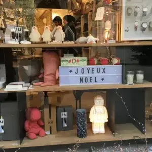 [a sign in a store window says Joyeaux Noel] French Christmas traditions, Joyeaux Noel