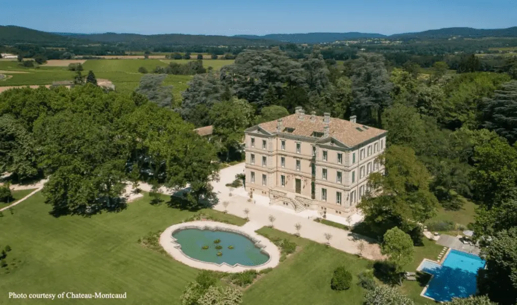 [lAn aerial view of a grand countryside mansion, surrounded by lush greenery and sprawling landscapes] chateaux near Avignon, vineyard stays,